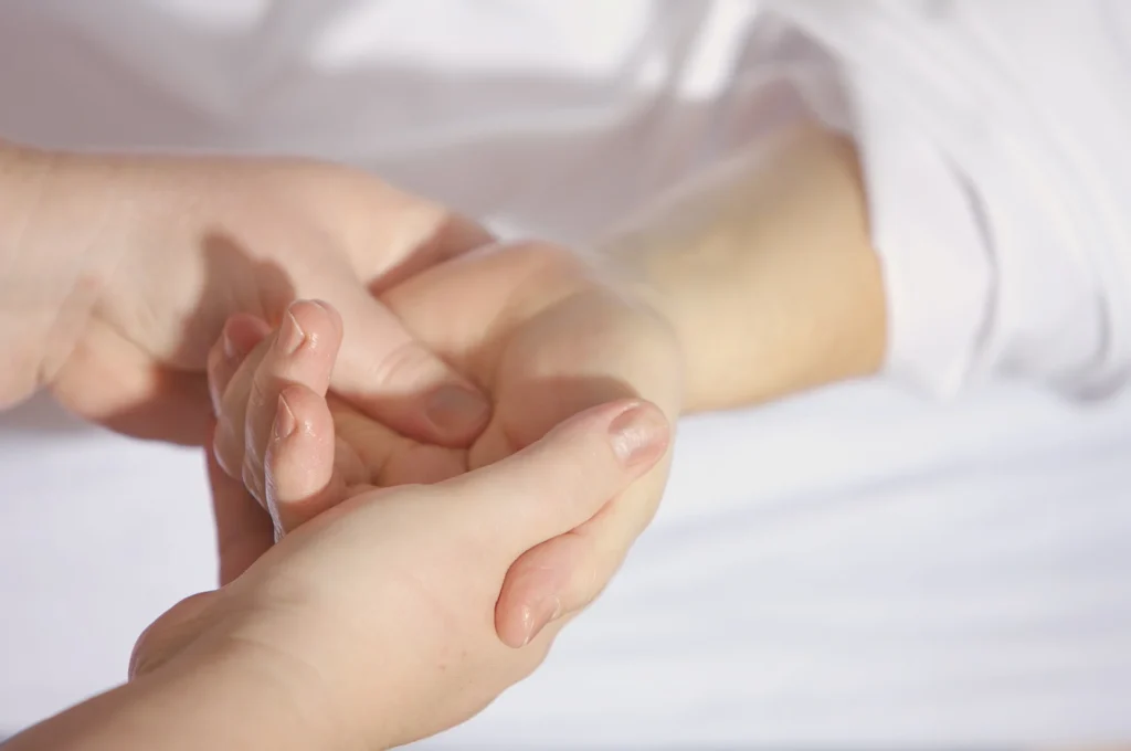 Therapeutic touch or massage treatment with hands gently holding